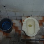 Thai style Squat Toliet with cleaning bucket and no TP
