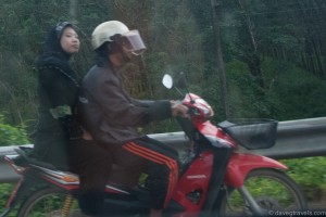 Muslim couple on scooter